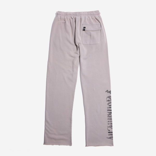 The back of light grey sweatpants with an elastic waistband, featuring a back pocket with button closure and a vertical "Gotham City" graphic printed in distressed black text along the lower left leg.