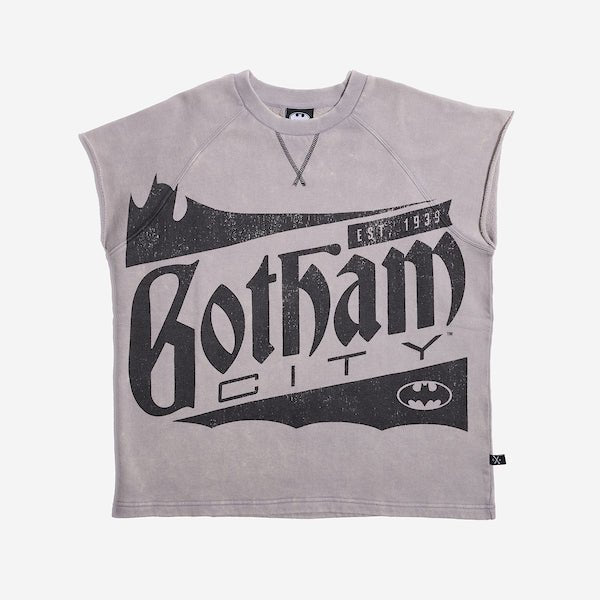 Sleeveless light gray sweatshirt featuring a large vintage-style graphic of "Gotham City" with a bat silhouette and the text "Est. 1939" in distressed black print. A small Batman logo is also present at the bottom right of the design