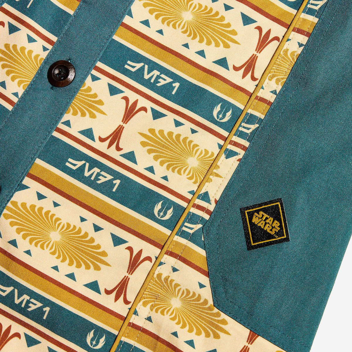 Close up of a button up yellow and teal dress thats star wars jedi inspired with a striped tapestry pattern