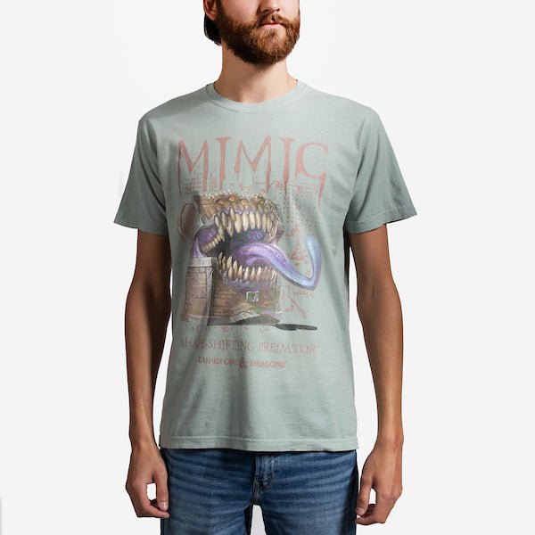 A man in a Light Green T-Shirt featuring a "Mimic" From Dungeons and Dragons