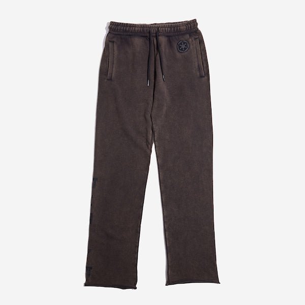 Black sweatpants with an elastic waistband and black drawstring, featuring a small black Empire logo near the left pocket and a vertical "Empire" graphic printed in distressed black text along the lower left leg.