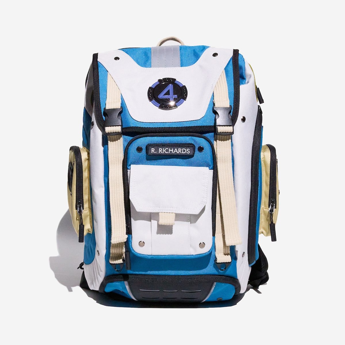Blue and white backpack with a metal "4" fantastic four emblem and "R. Richards" patch on the front of the bag