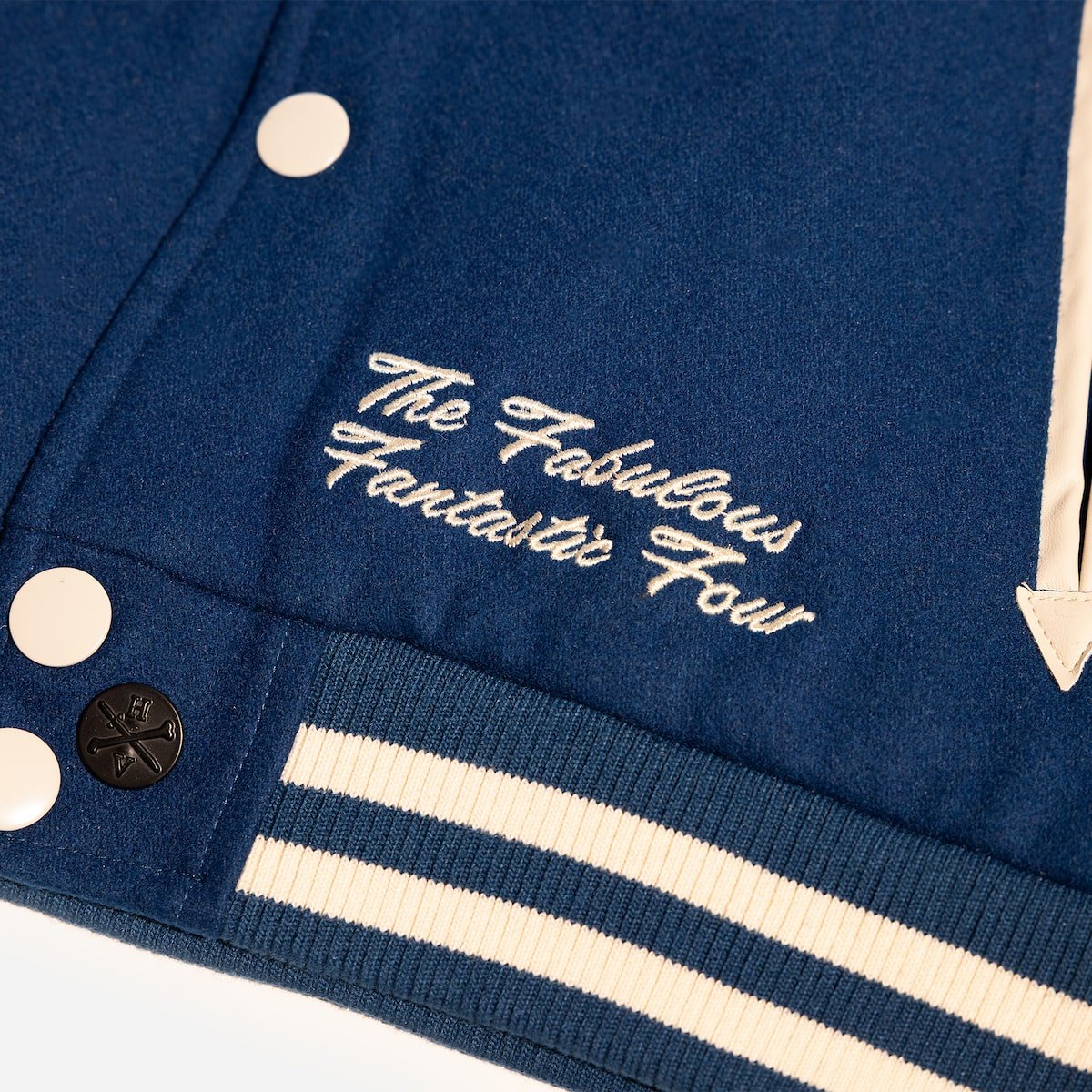 Close-up of a blue jacket with white text and buttons on a white background