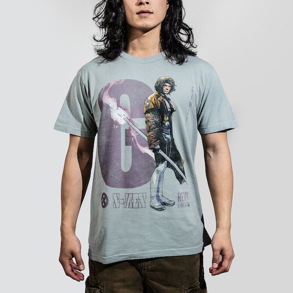Man in a light blue t-shirt featuring a faded graphic of Gambit from X-Men