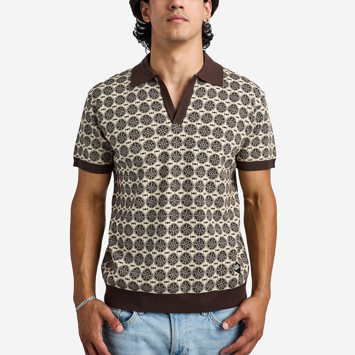 Man wearing a brown star wars patterned polo with brown collar and trim on a white background