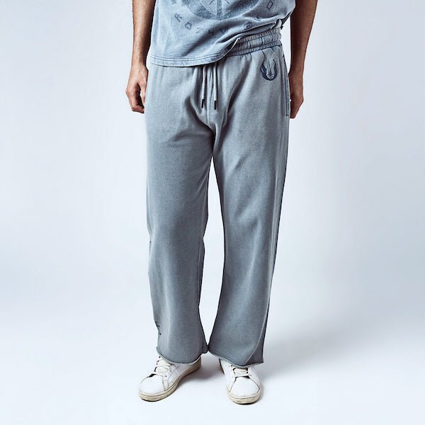 Man in Light Blue sweatpants with an elastic waistband and black drawstring, featuring a small blue jedi logo near the left pocket and a vertical "jedi knights" graphic printed in distressed blue text along the lower left leg.