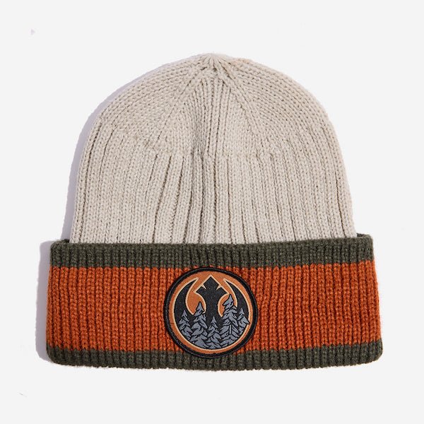 Photo shows a beige knit beanie. This beanie has a folded cuff that has a wide orange stripe between two smaller dark green stripes on the top and bottom. There is a patch embroided on the center of the cuff. The patch features the REBEL emblem from Star Wars with a wooded motif within the Rebel emblem.