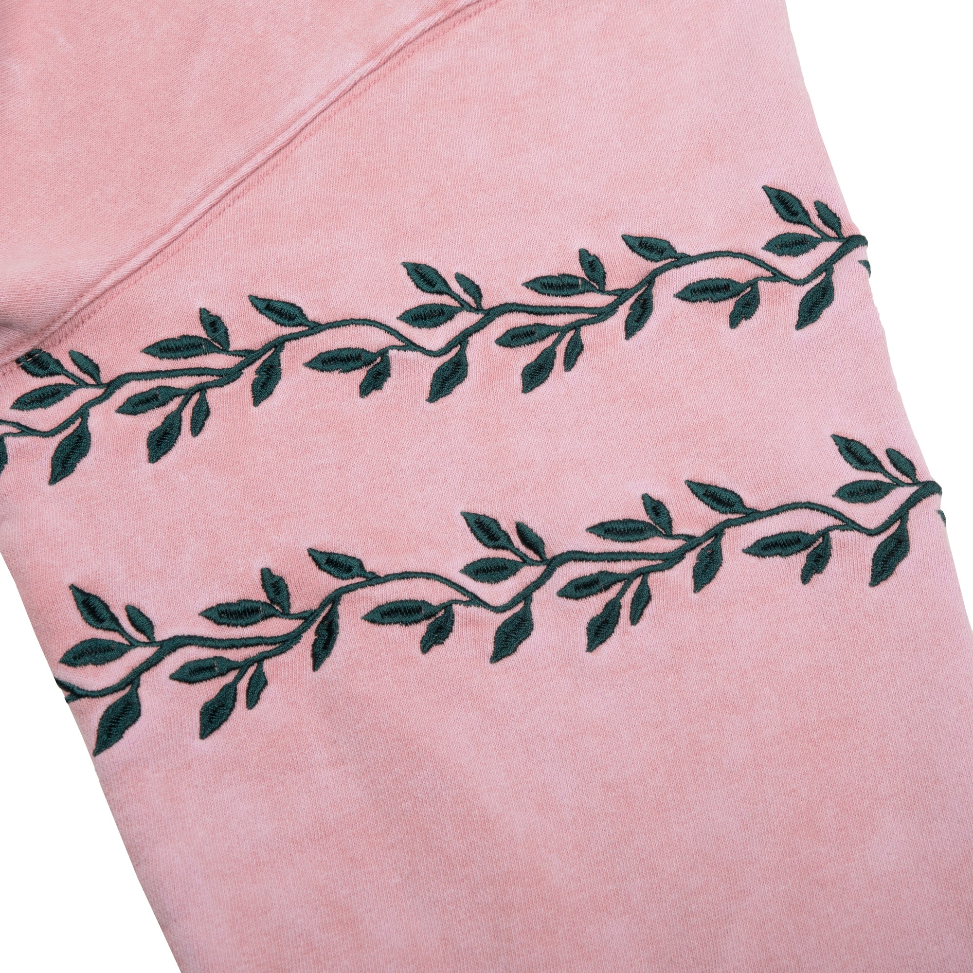 Close-up of the green vine embroidery on the Breathe In Breathe Out Blush Crew Sweatshirt.