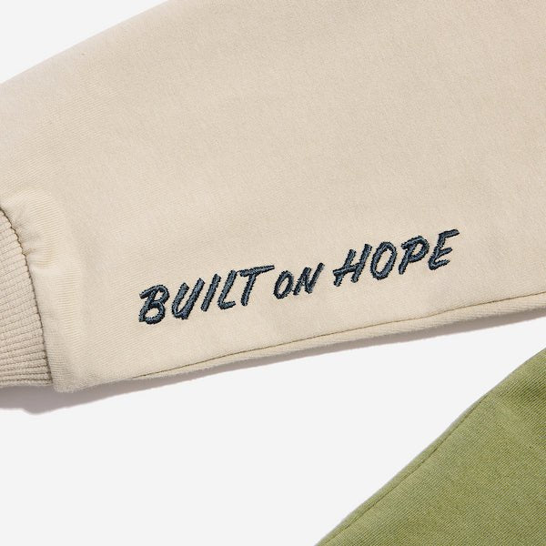 A close up of the sleeve detailing that says "Built on hope"