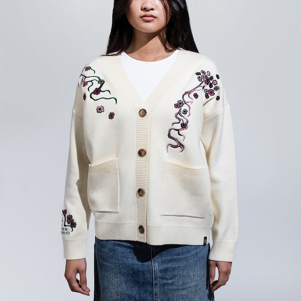 Woman in a White Button Up Cardigan featuring embroidered cherry blossoms