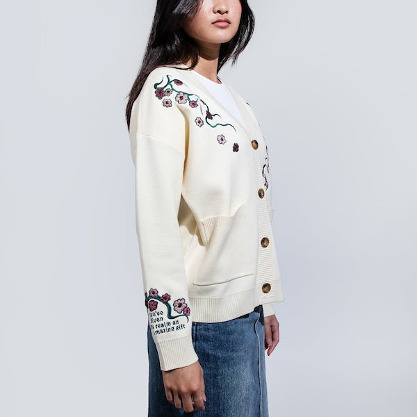 Woman in a White Button Up Cardigan featuring embroidered cherry blossoms