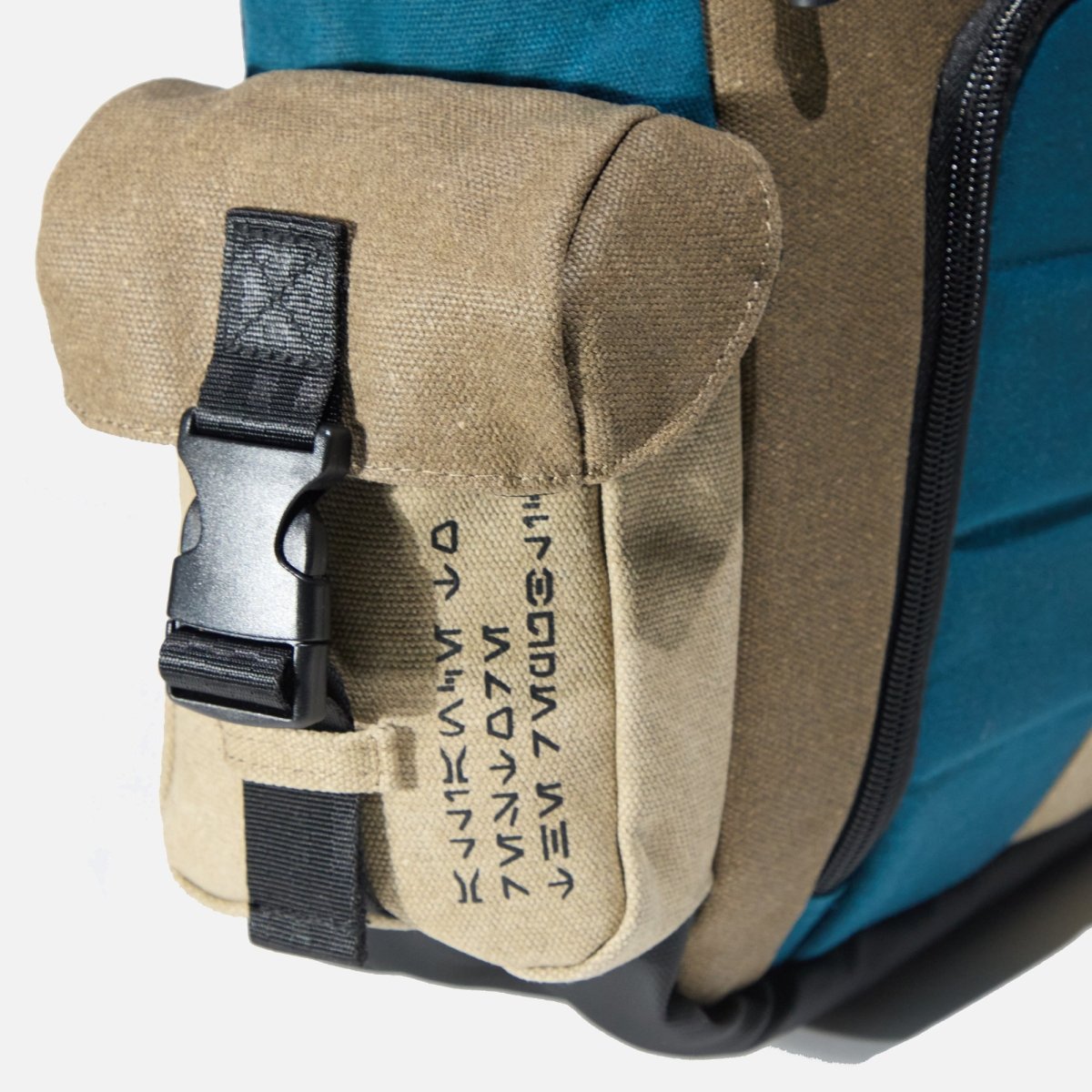Close up of the buckle clip pocket on the side of the Heroes & Villains Rebel Teal Commuter Bag