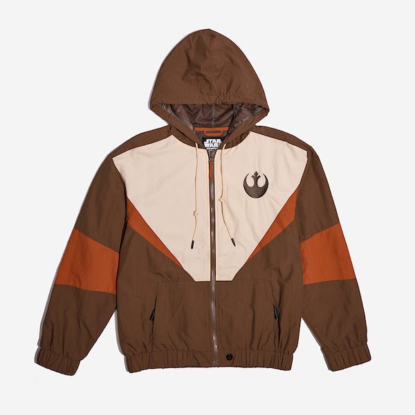 A Star Wars-themed hooded windbreaker jacket featuring a Rebel Alliance emblem on the left chest. The jacket has a color-blocked design in brown, beige, and orange, with a front zipper, adjustable drawstrings on the hood, elastic cuffs, and two zippered pockets. The overall aesthetic is inspired by the Rebel pilot uniforms from the Star Wars universe