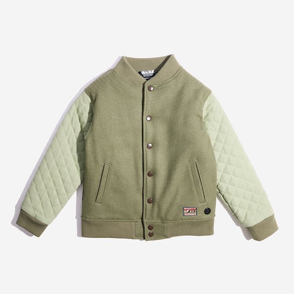 An olive green varsity-style jacket with quilted light green sleeves. The body of the jacket is made of a soft, solid fabric, while the sleeves have a diamond-quilted pattern. It features a ribbed collar, cuffs, and hem, along with a button-up front closure with metallic snap buttons. Two slanted front pockets are integrated into the design. A small rectangular patch with is sewn onto the lower left side of the jacket. The patch features the words "REBELS OF" at the top and "ALDERAAN" at the bottom.