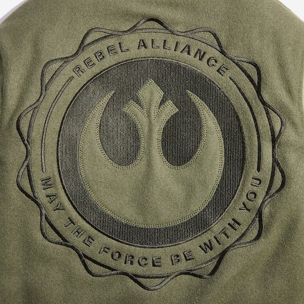 The photo shows a close up of a large circular embroidery featuring the Star Wars Rebel emblem. There is text that says "Rebel Alliance" at the top and "May the force be with you" at the bottom in a circular shape around the rebel emblem.