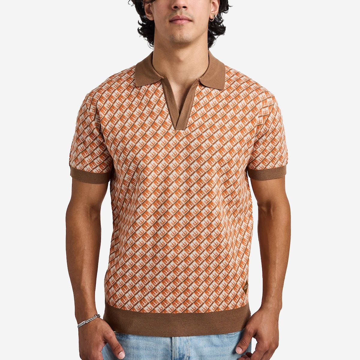 Man wearing an orange star wars patterned polo shirt with brown accents on a white background
