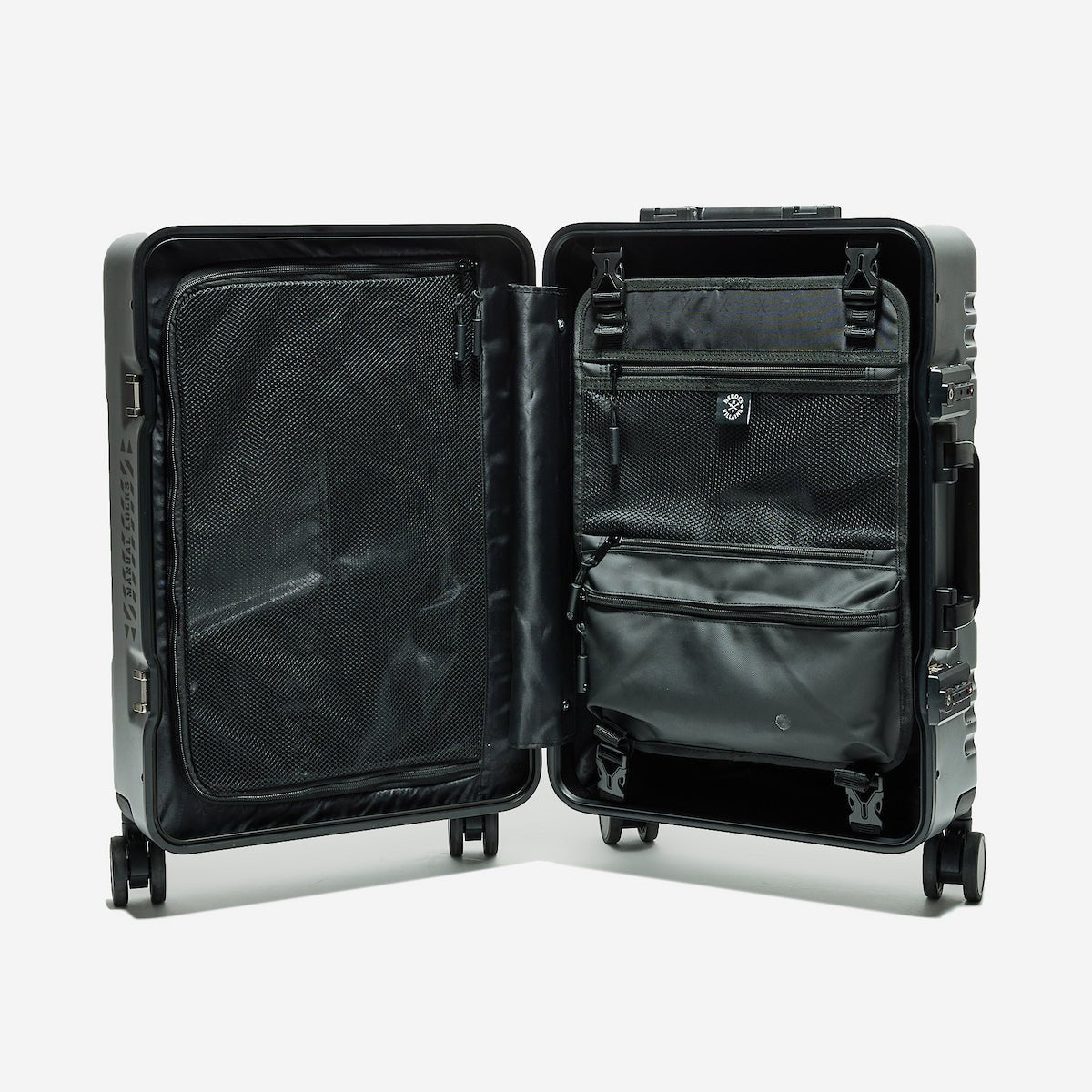 Black suitcase with open compartments on a white background