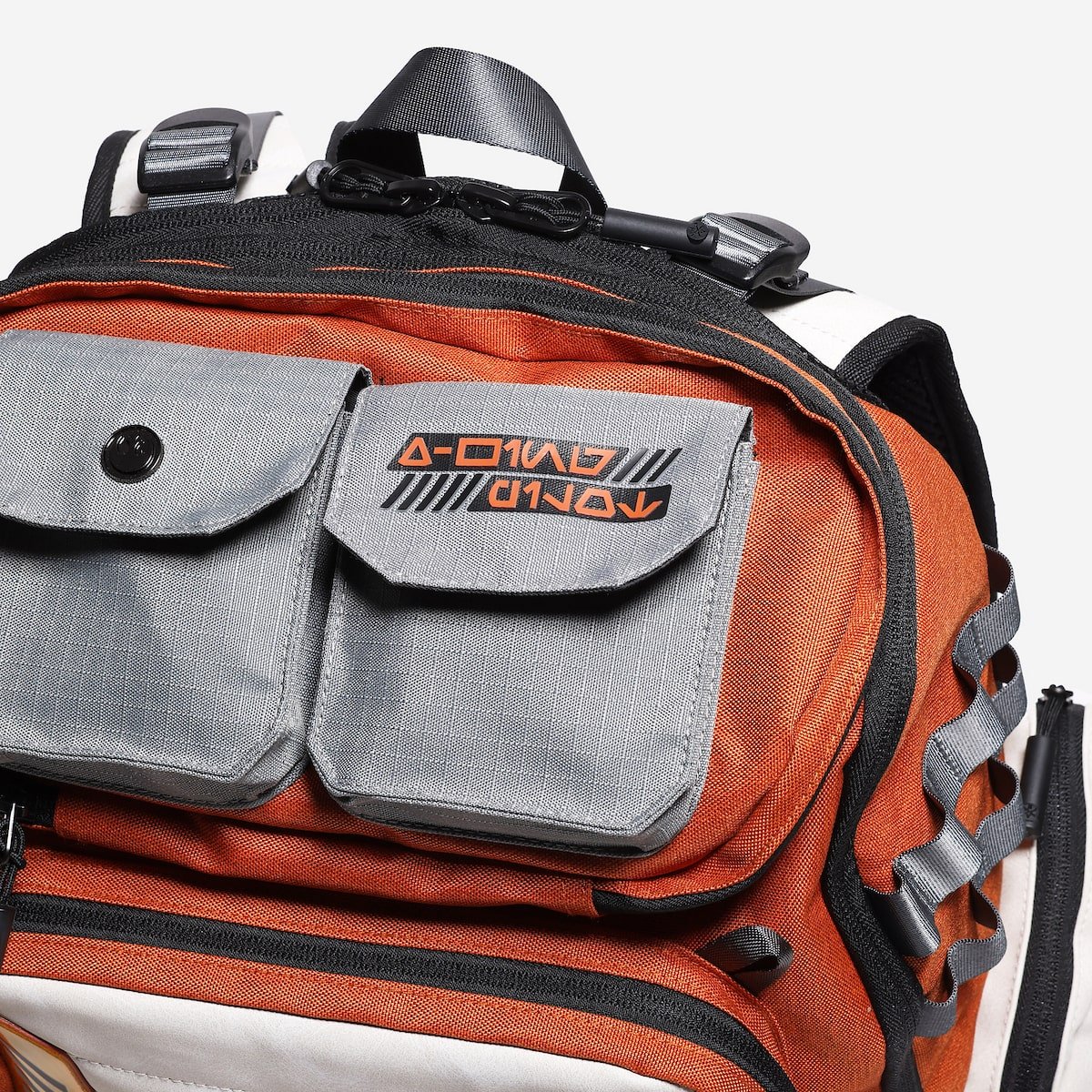 Orange and gray rebel backpack with a visible brand logo on a white background