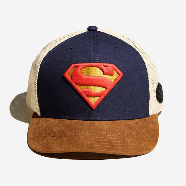 A photo of a trucker hat. It has a white mesh back, a brown suede bill and the front is blue dawning the S-Shield from Supermans uniform