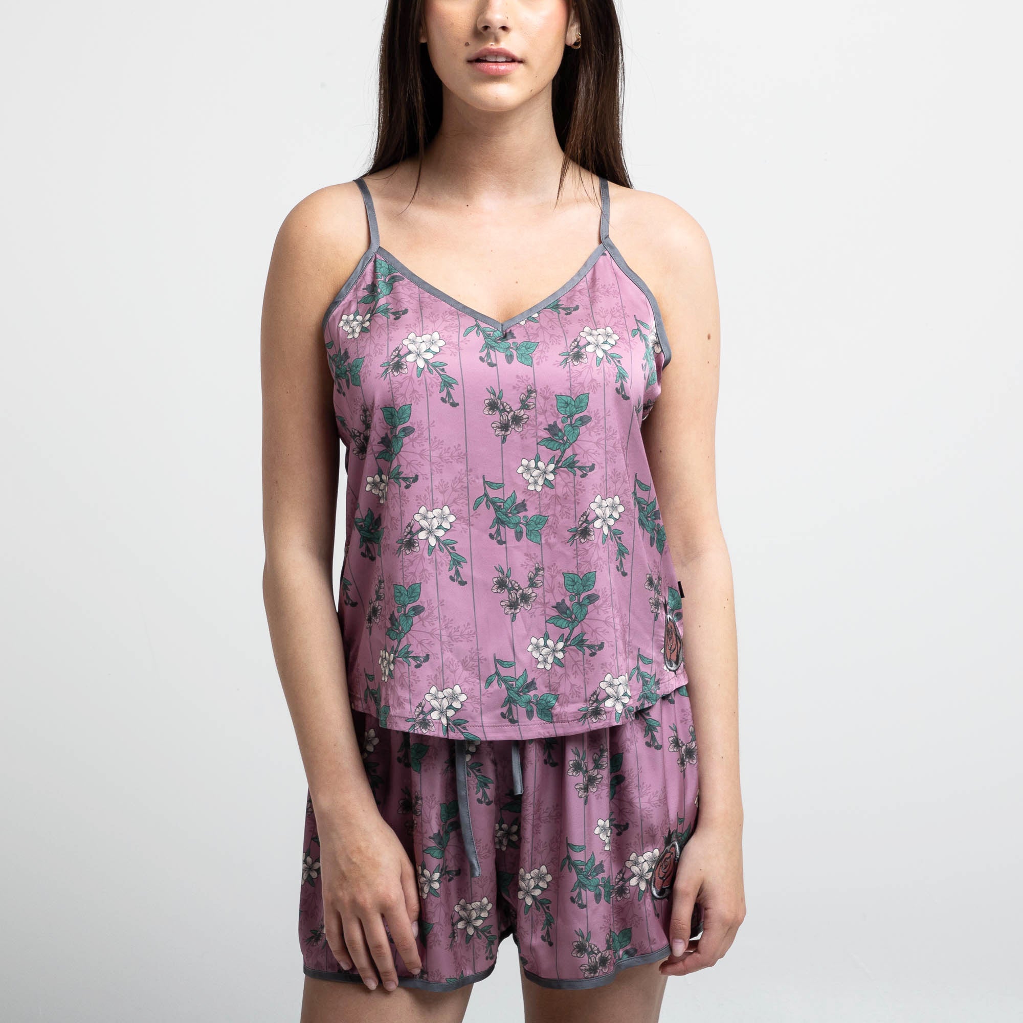 Female modeling fit of the Front view of the Lore Olympus Goddess of Spring Satin Cami in pink with an all-over floral print.