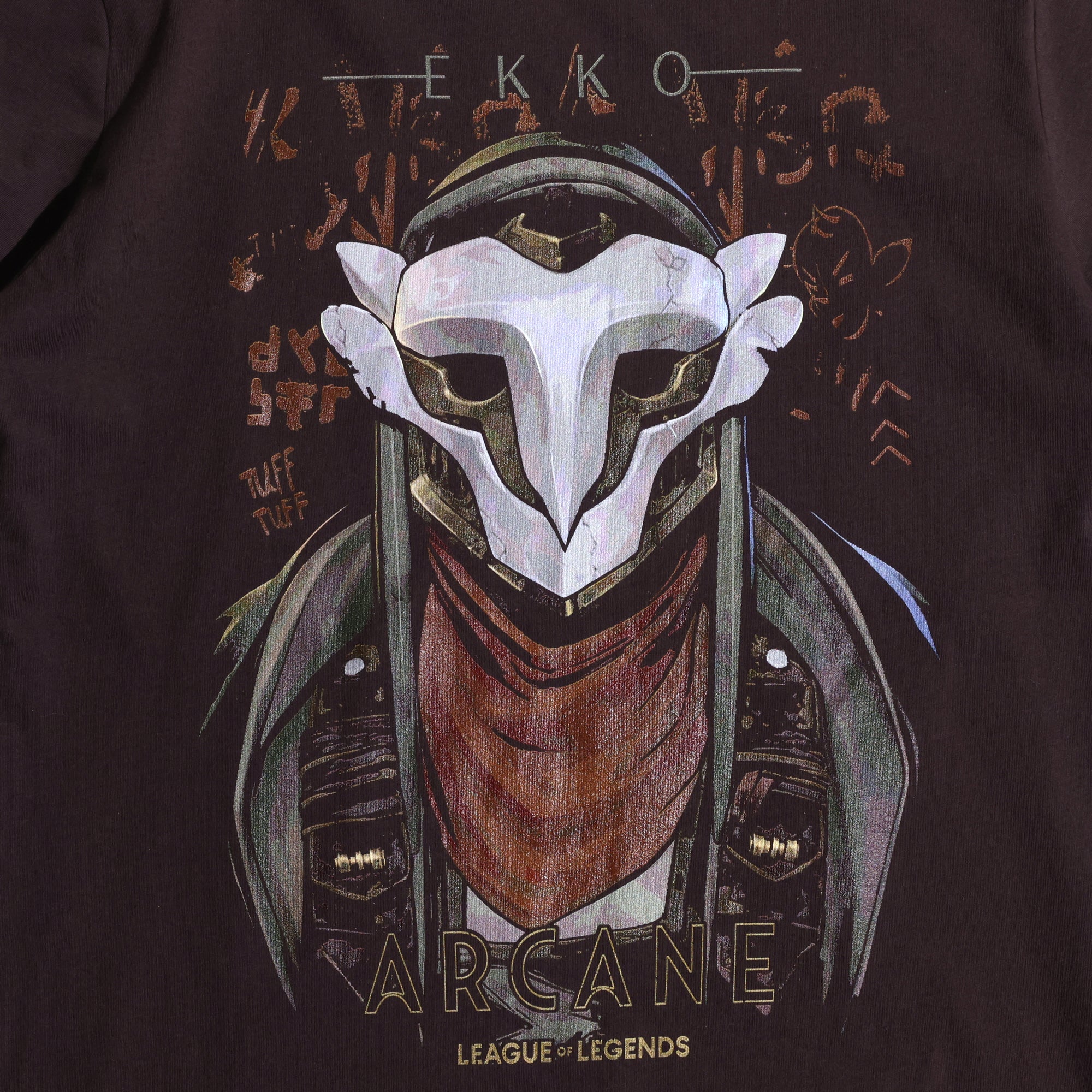 A brown Arcane x League of Legends t-shirt featuring Ekko wearing his signature mask and red scarf. The design includes stylized graffiti-like text, with ‘Ekko’ at the top and ‘Arcane’ and ‘League of Legends’ at the bottom in a bold font