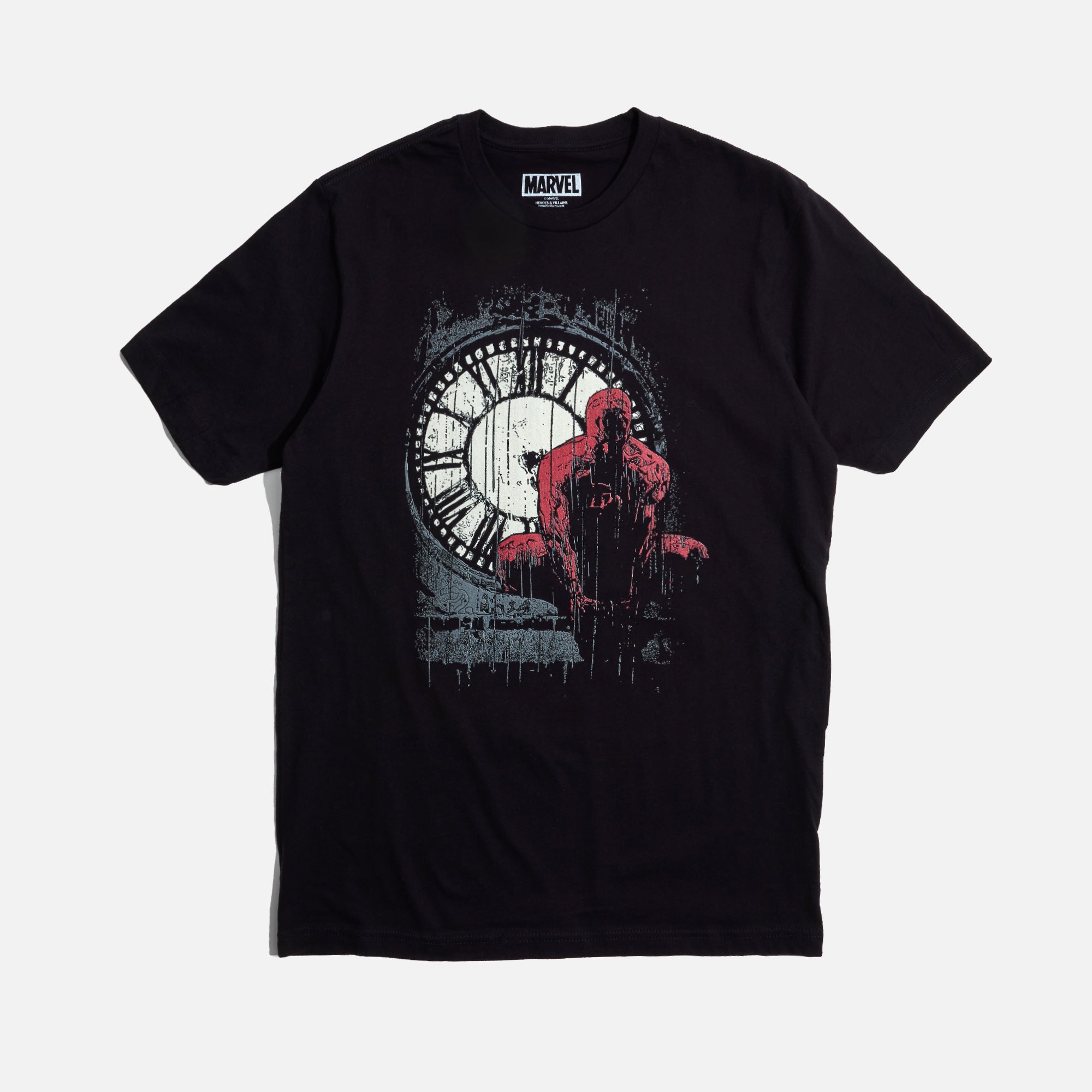 A Moody, black, graphic tee featuring Daredevil crouched in front of a weathered clock tower, drenched in rain. The distressed artwork and bold red highlights capture the grit and intensity of Hell’s Kitchen’s vigilante.