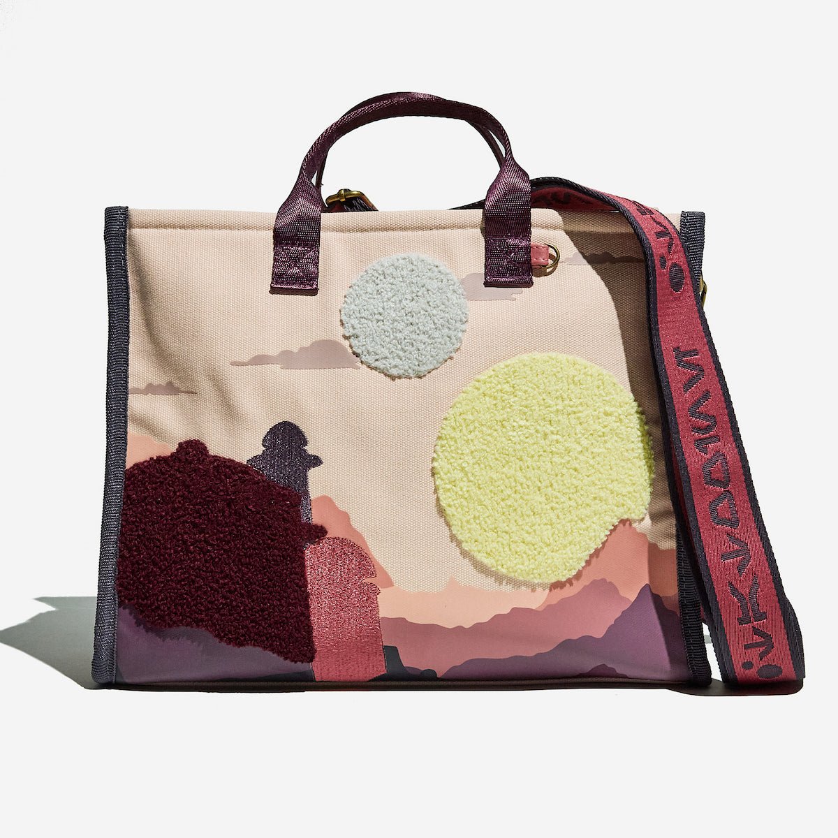 Beige bag with artistic Star Wars Tatooine design and textured elements on a white background