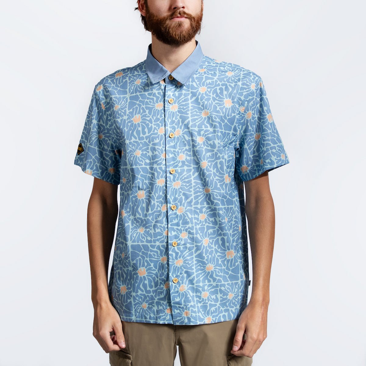 A man in a blue button down star wars rebel shirt with 60s inspired patterns