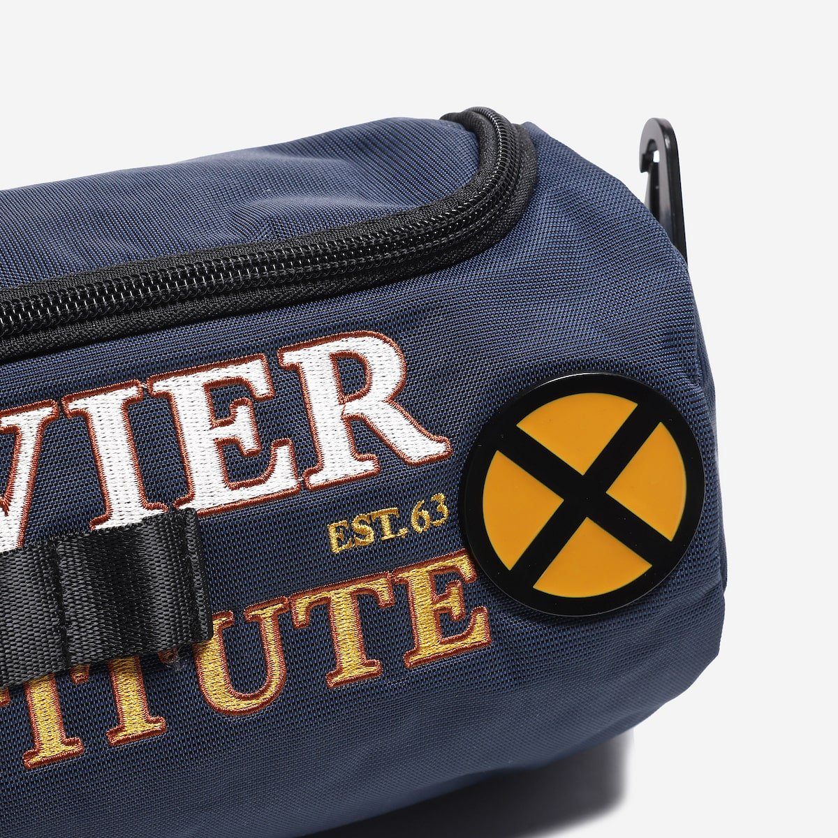 Navy blue bag with embroidered text and a circular patch on a white background