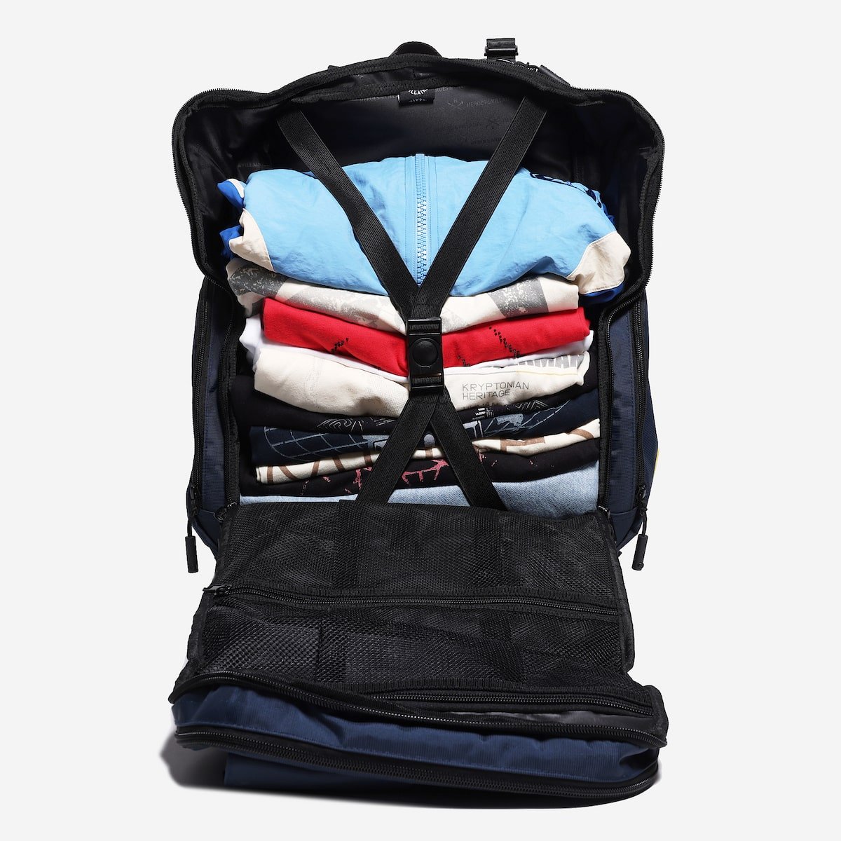 Backpack with clothes neatly packed inside on a white background