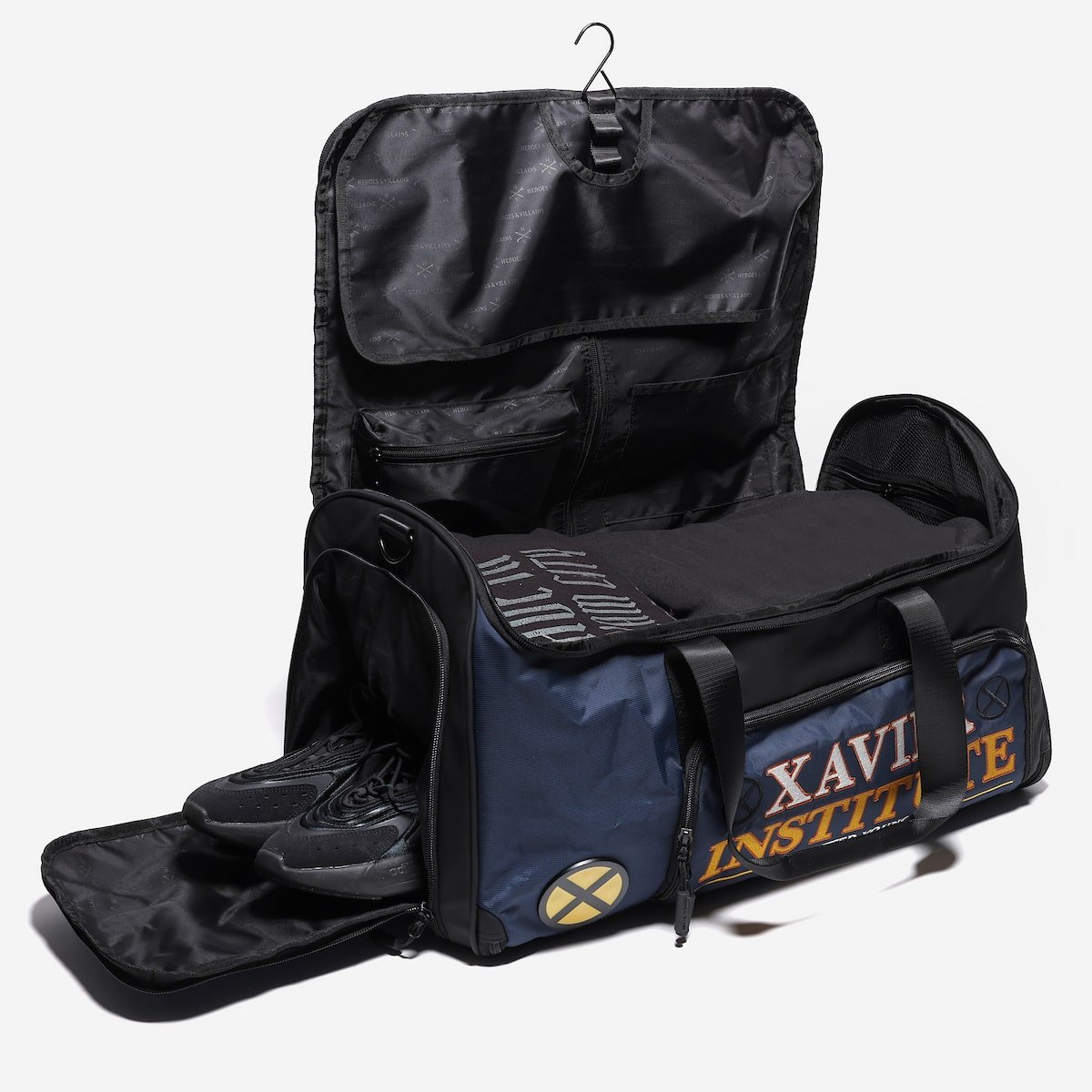Blue and Black duffel bag with open compartment revealing a shoe, on a white background.