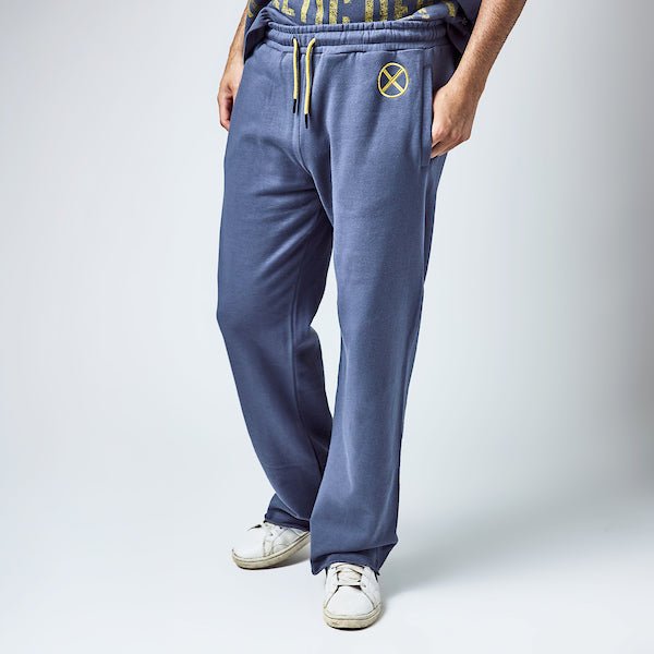 Man in Blue sweatpants with an elastic waistband and yellow drawstring, featuring a small yellow x-men logo near the left pocket and a vertical "Xavier" graphic printed in distressed yellow text along the lower left leg.