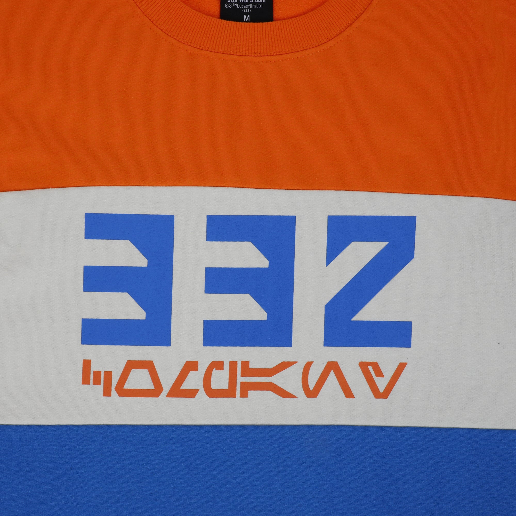 Close-up of 332 Company Colorblock Sweatshirt with orange, white, and blue panels and screen printed art on front.