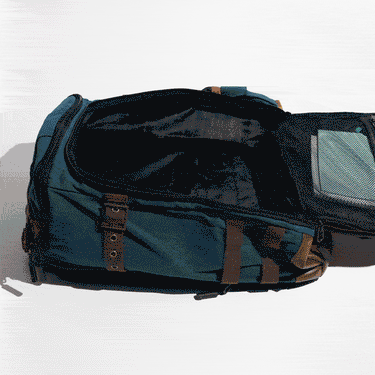 GIF Showing D&D Books, Spiral Note Books and a Foldable Graph being packed into the D&D Quest Backpack showing how many items it can carry.