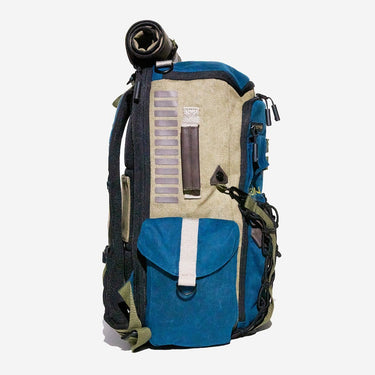 Blue and beige backpack with rolled-up Back Cover on a white background