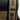 Close-up of a brown mandalorian theme backpack showing a close up of the strap with a Grogu graphic reading "Mandalorian" in the Star Wars language Mando'a