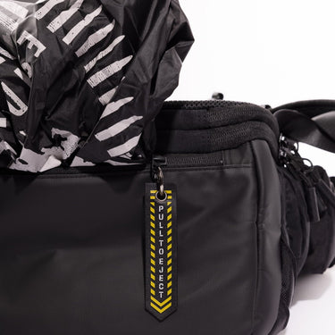 Black bag with a pull-to-eject tag showing a zipper pocket with a rain cover on a white background