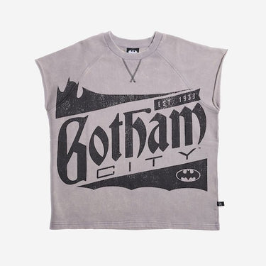 Sleeveless light gray sweatshirt featuring a large vintage-style graphic of "Gotham City" with a bat silhouette and the text "Est. 1939" in distressed black print. A small Batman logo is also present at the bottom right of the design