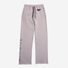 Light gray sweatpants with an elastic waistband and black drawstring, featuring a small black Batman logo near the left pocket and a vertical "Gotham City" graphic printed in distressed black text along the lower left leg.