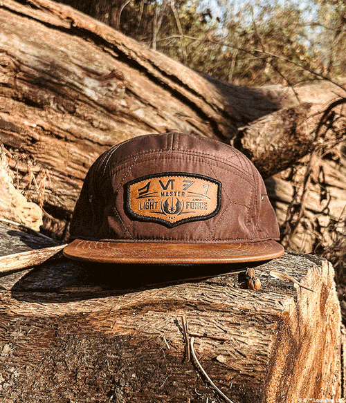 a brown hat on a log