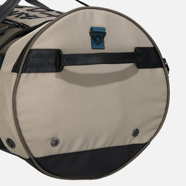 Rugged duffle bag in earthy tones with black straps, blue accent detailing, and a durable design. Features multiple compartments, reinforced handles, and an adjustable shoulder strap for versatile carrying.