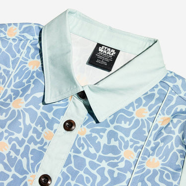 Close up of a blue star wars rebel dress with 60s inspired patterns. The photo focuses on the collar detail and buttons. 