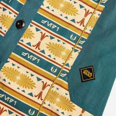 Close up of a button up yellow and teal dress thats star wars jedi inspired with a striped tapestry pattern 