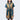 A woman in a button up yellow and teal dress thats star wars jedi inspired with a striped tapestry pattern 