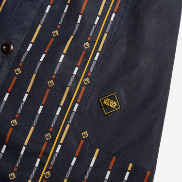 Close up of a button up navy dress thats star wars rebel inspired with a striped pattern 