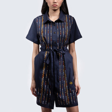 Woman in a button up navy dress thats star wars rebel inspired with a striped pattern 
