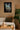 Living room with a star wars canvas on the wall, a couch, and a plant.