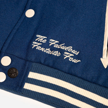 Close-up of a blue jacket with white text and buttons on a white background