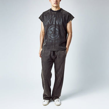 A man dressed in a black sleeveless crew neck and black wide leg sweatpants, featuring a Star Wars Empire themed lounge set