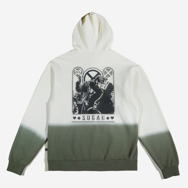 A dip-dyed hoodie in cream and green featuring X-Men's Rogue and Gambit. The front displays a small X-Men logo, while the back showcases a black-and-white comic-style illustration of Rogue and Gambit embracing, with the word "Sugah" below.